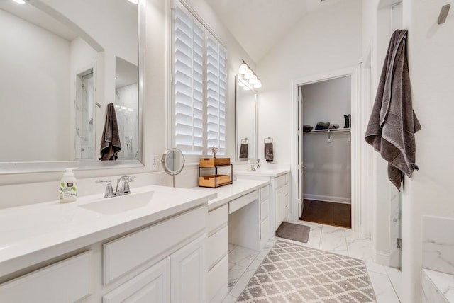 full bathroom with vanity, a marble finish shower, vaulted ceiling, a walk in closet, and marble finish floor