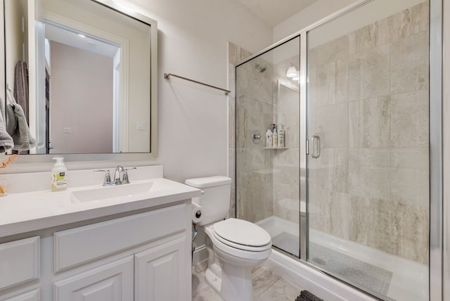 bathroom with vanity, toilet, marble finish floor, and a shower stall