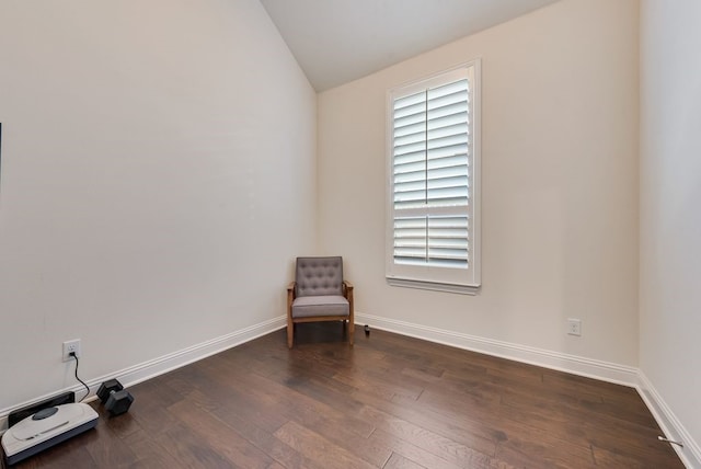 unfurnished room with baseboards, wood finished floors, and vaulted ceiling