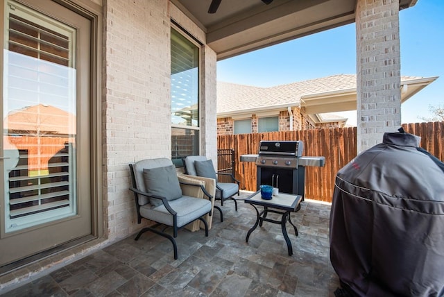 view of patio featuring area for grilling and fence