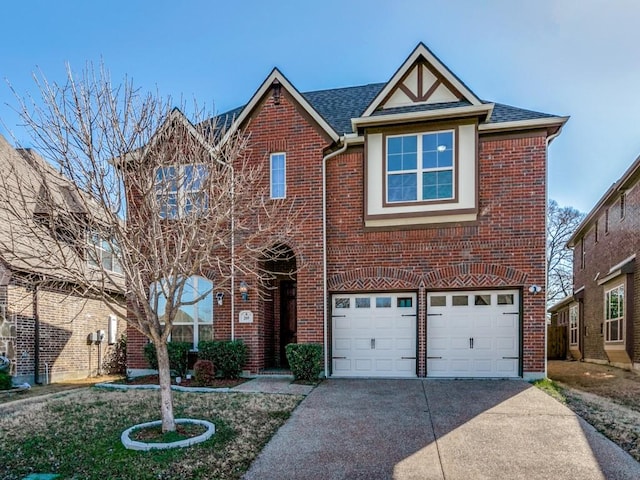 traditional-style home with brick siding, an attached garage, roof with shingles, and driveway