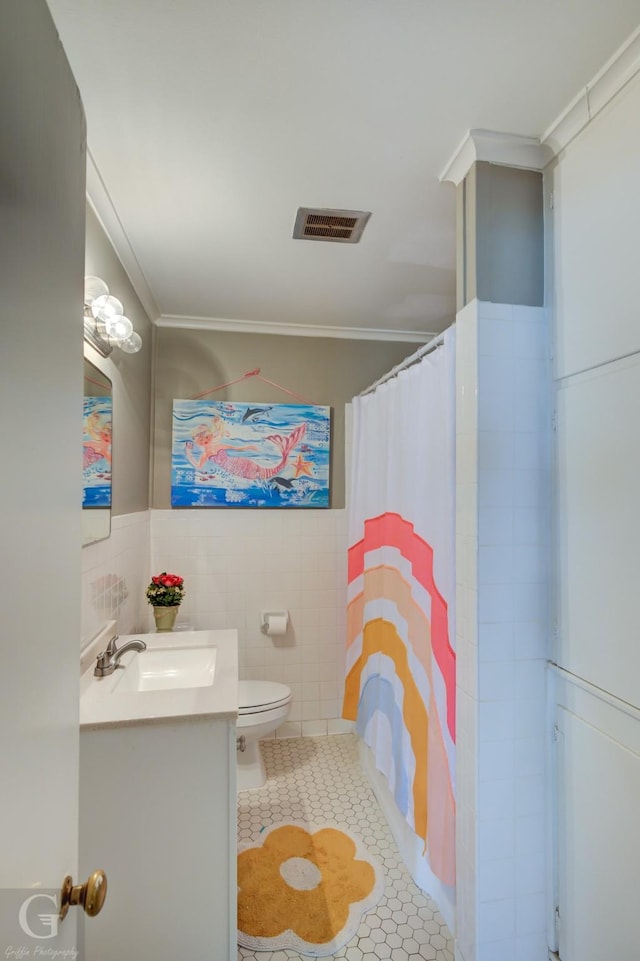 bathroom featuring vanity, tile patterned floors, visible vents, and ornamental molding