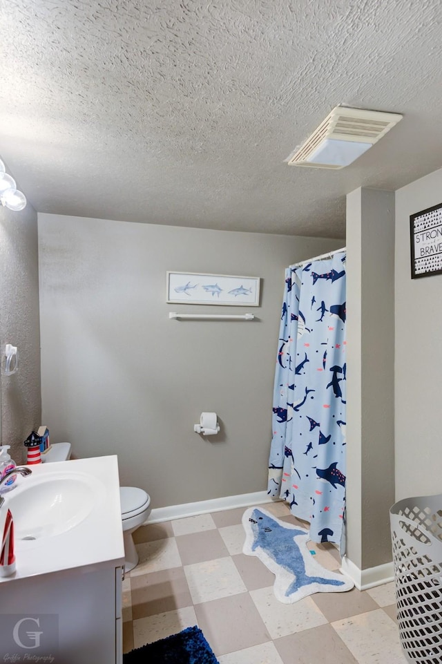 full bath with vanity, baseboards, visible vents, tile patterned floors, and toilet