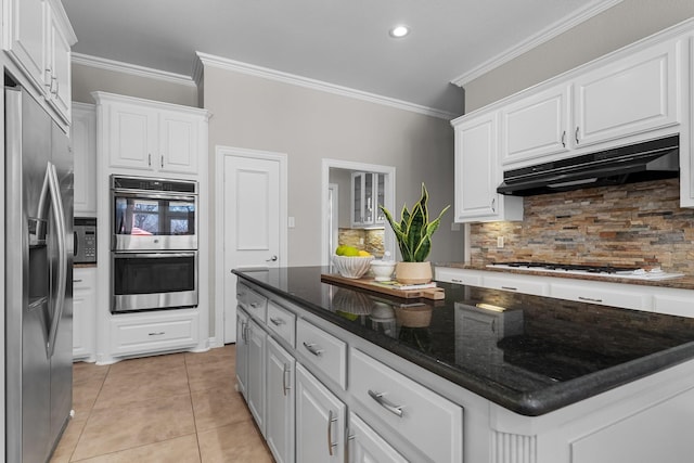 kitchen with under cabinet range hood, appliances with stainless steel finishes, and white cabinets