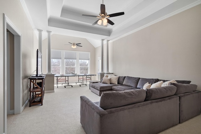 living area featuring ornamental molding, a ceiling fan, a tray ceiling, light colored carpet, and ornate columns