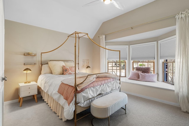 carpeted bedroom with baseboards, lofted ceiling, and a ceiling fan