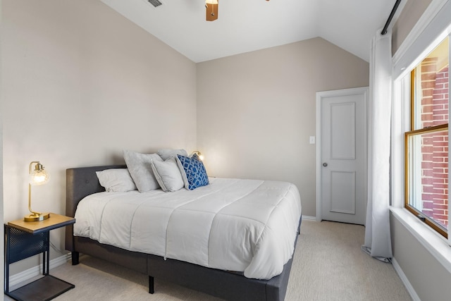 bedroom featuring a ceiling fan, baseboards, visible vents, vaulted ceiling, and light colored carpet