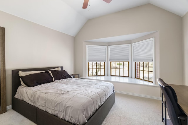 bedroom with vaulted ceiling, multiple windows, and light carpet