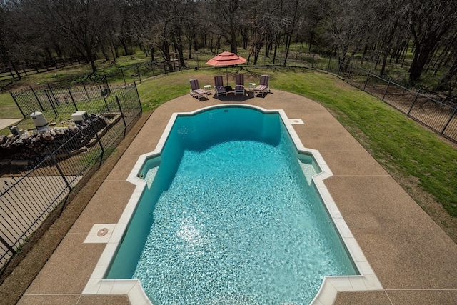 view of swimming pool with a fenced in pool, a lawn, a fenced backyard, and a patio area