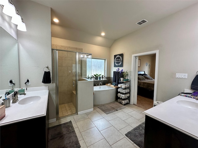 bathroom featuring visible vents, a soaking tub, a stall shower, a sink, and vaulted ceiling