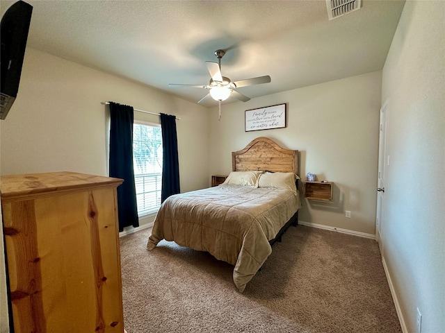 bedroom with ceiling fan, carpet, visible vents, and baseboards