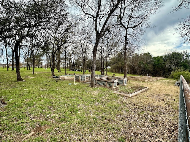 view of community with a garden and a yard