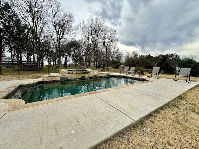 view of pool with a patio, a pool with connected hot tub, and fence