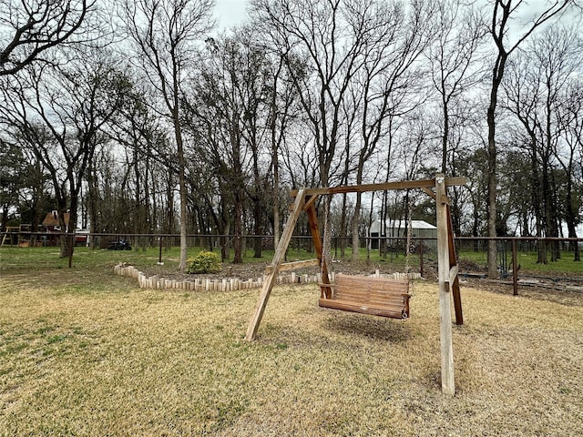 view of play area featuring a lawn and fence