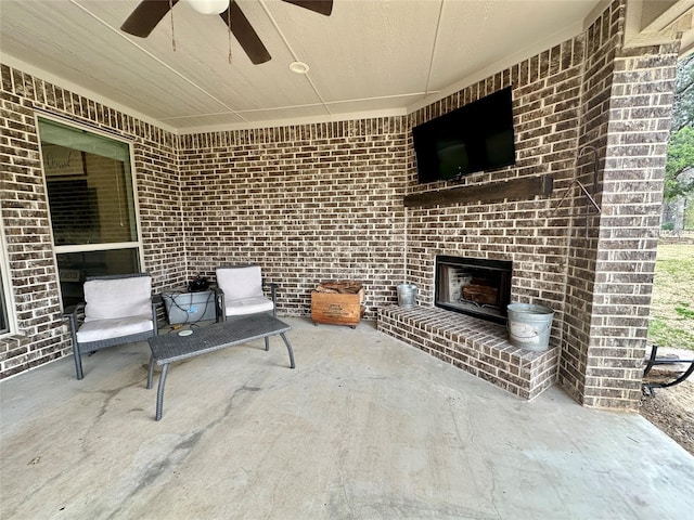 view of patio featuring an outdoor brick fireplace and ceiling fan