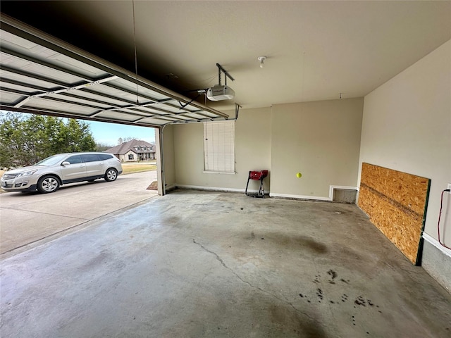 garage featuring baseboards and a garage door opener