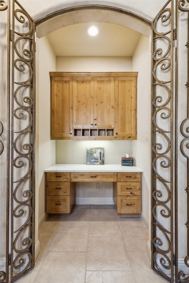 exercise room with crown molding, wood finished floors, and baseboards