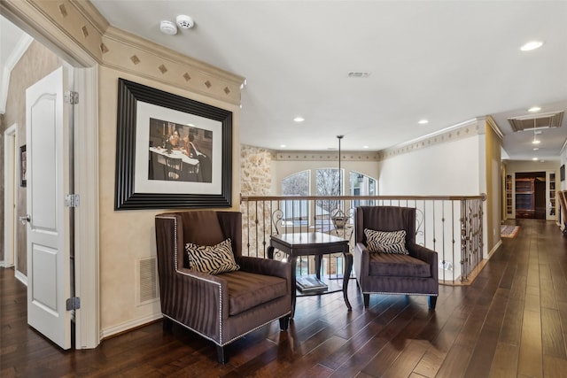 sitting room featuring visible vents, attic access, baseboards, and wood finished floors