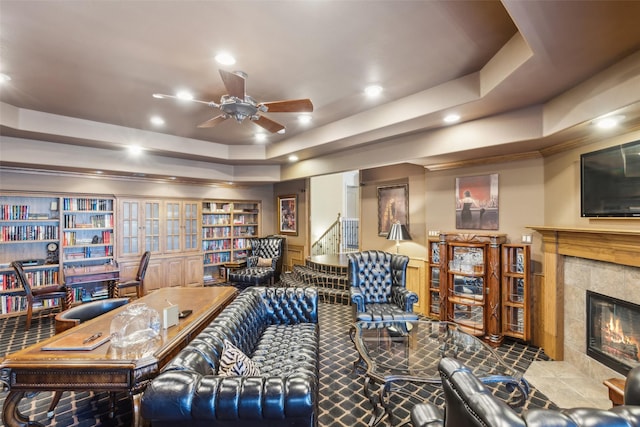 office with recessed lighting, a tile fireplace, a tray ceiling, and ceiling fan