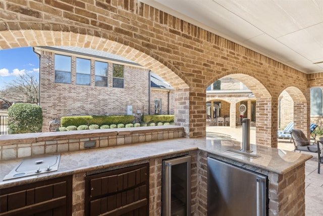 view of patio / terrace featuring area for grilling and wine cooler