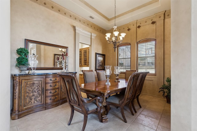 dining room featuring visible vents, crown molding, a tray ceiling, and an inviting chandelier