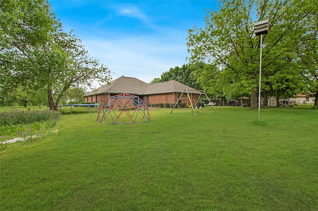 view of yard featuring a trampoline and a playground