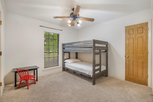 bedroom with crown molding, a ceiling fan, baseboards, and carpet floors