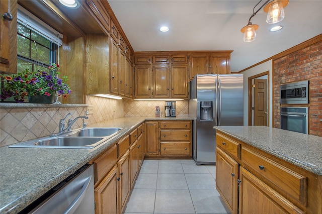 kitchen with ornamental molding, a sink, tasteful backsplash, appliances with stainless steel finishes, and light tile patterned floors