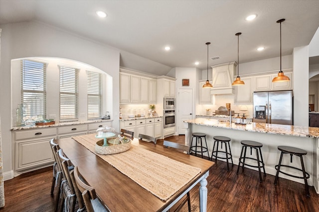 dining room with recessed lighting, visible vents, dark wood-style flooring, and vaulted ceiling