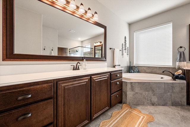 full bath featuring tile patterned flooring, visible vents, a garden tub, vanity, and a shower