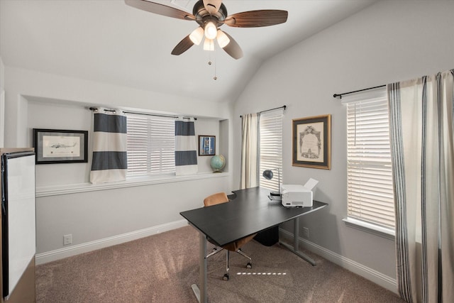 office area with baseboards, carpet, ceiling fan, and vaulted ceiling