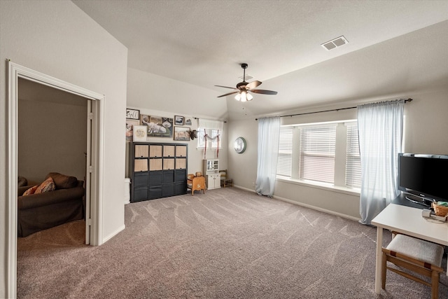 carpeted bedroom featuring vaulted ceiling, baseboards, visible vents, and ceiling fan