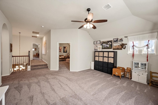 interior space with lofted ceiling, an upstairs landing, carpet, and visible vents