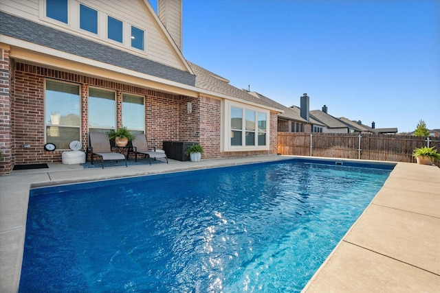 view of swimming pool with a fenced in pool, a patio area, and fence