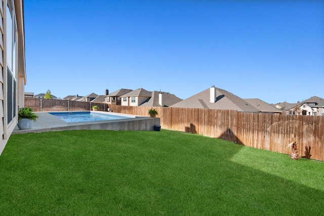 view of yard featuring a patio area, a fenced in pool, a residential view, and a fenced backyard