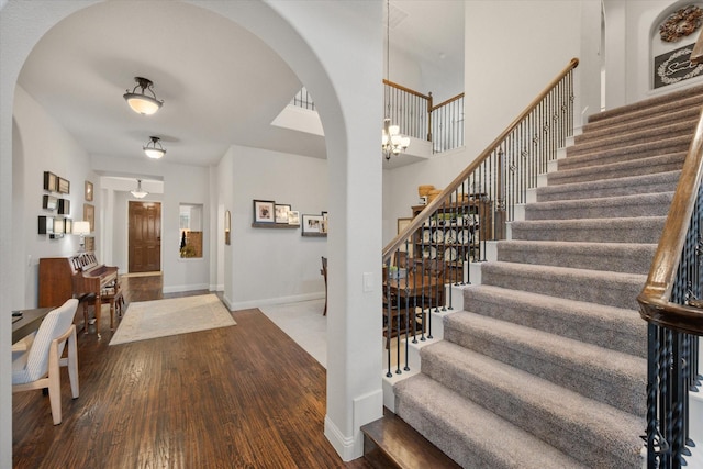 entrance foyer with stairway, baseboards, and wood finished floors