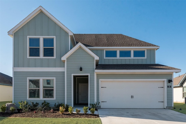 view of front of home featuring board and batten siding, concrete driveway, an attached garage, and a shingled roof