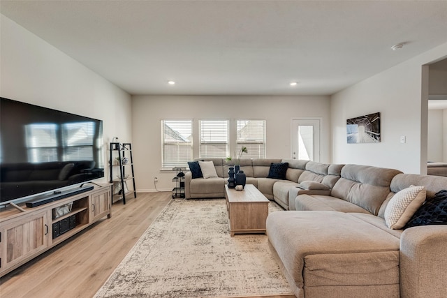 living area featuring recessed lighting, light wood-style flooring, and baseboards