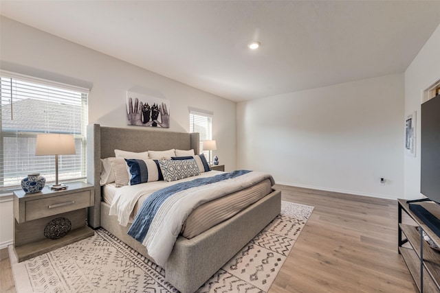 bedroom with light wood-style flooring, recessed lighting, and baseboards