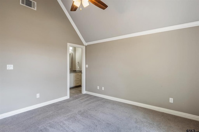 carpeted spare room with visible vents, high vaulted ceiling, a ceiling fan, crown molding, and baseboards