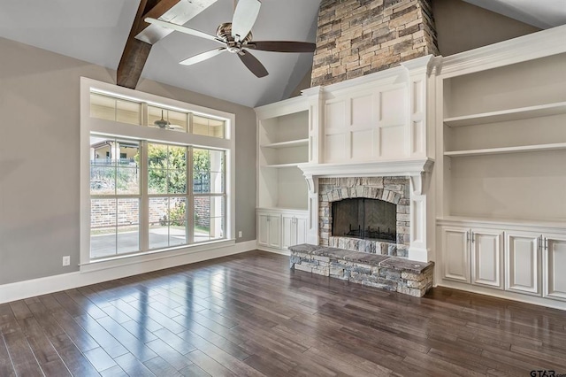 unfurnished living room featuring dark wood finished floors, a stone fireplace, built in features, and ceiling fan