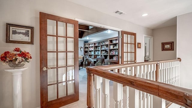 hallway with recessed lighting, visible vents, and french doors