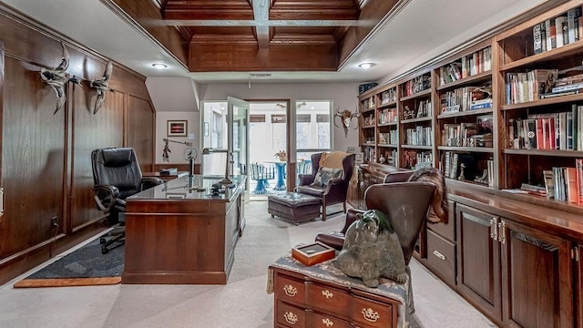 office space featuring beamed ceiling, coffered ceiling, ornamental molding, and light colored carpet