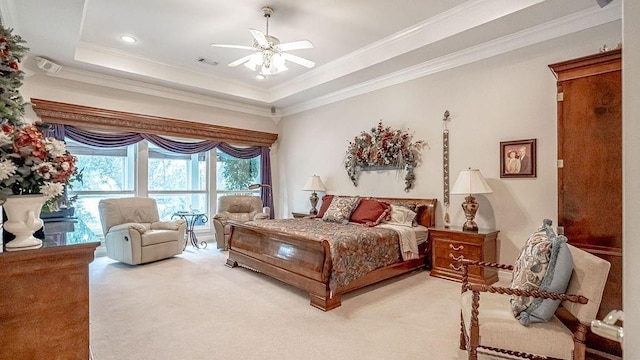 carpeted bedroom with ceiling fan, visible vents, a raised ceiling, and ornamental molding