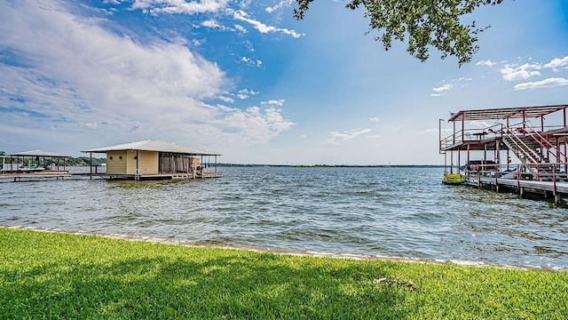 dock area with a water view and boat lift