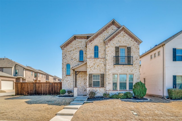 814 Davids Way, Allen, TX 75013 - view of front of house featuring stone siding, a balcony, and fence