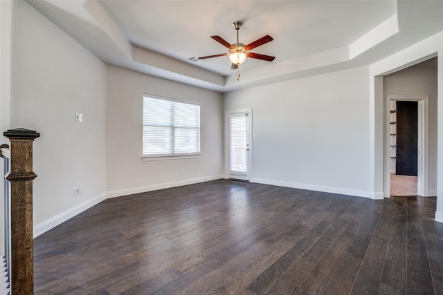 814 Davids Way, Allen, TX 75013 - unfurnished room featuring a ceiling fan, dark wood-style floors, visible vents, baseboards, and a tray ceiling