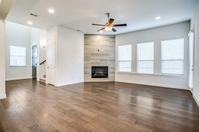 814 Davids Way, Allen, TX 75013 - unfurnished living room with a tiled fireplace, visible vents, a healthy amount of sunlight, and wood finished floors