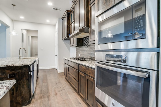 814 Davids Way, Allen, TX 75013 - kitchen featuring dark brown cabinetry, visible vents, stainless steel appliances, and a sink