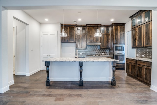 814 Davids Way, Allen, TX 75013 - kitchen with under cabinet range hood, stainless steel appliances, dark brown cabinetry, and dark wood finished floors
